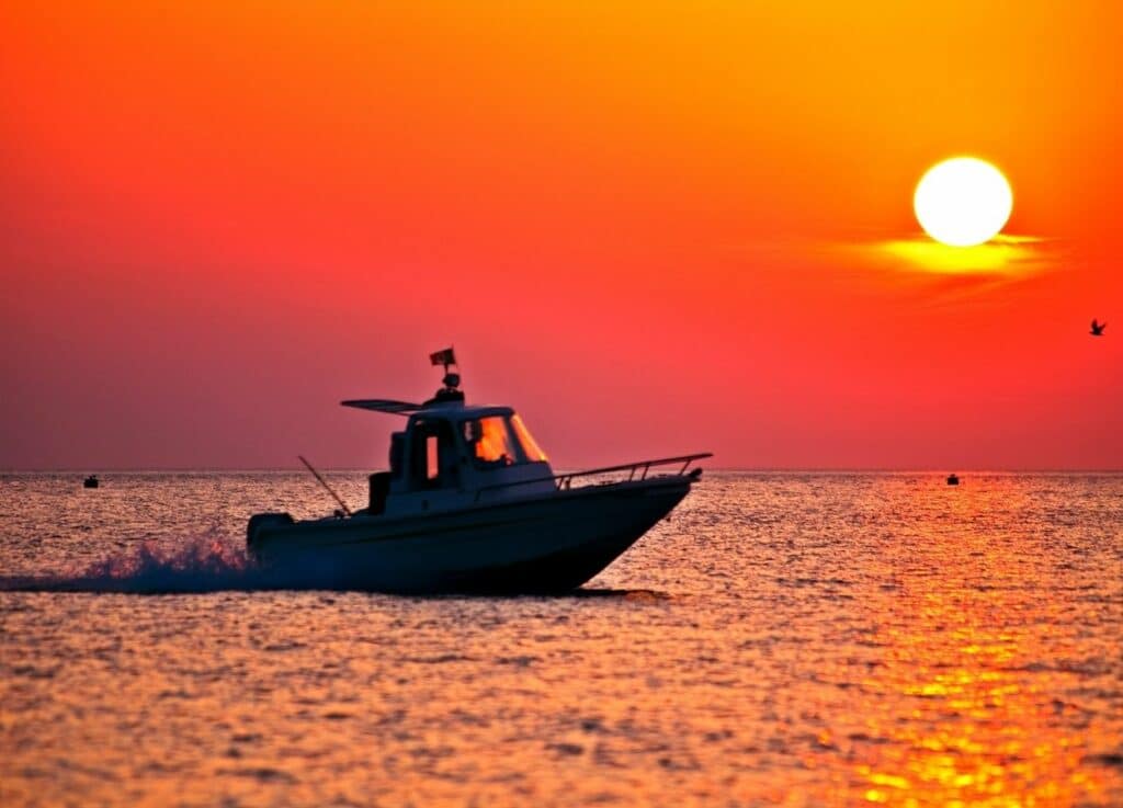A boat in the sea at sunset time