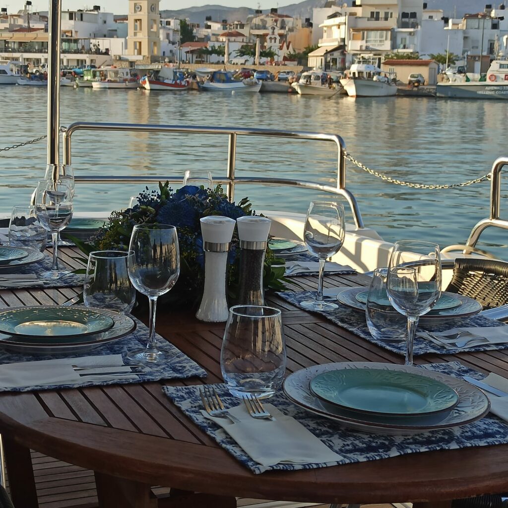 A table set with plates and glasses on a yacht