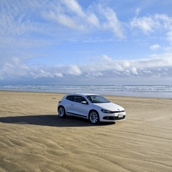 A car driving on a sandy beach